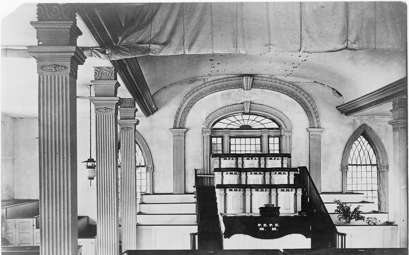 The Melchizedek Priesthood pulpits at the west end of the Kirtland Temple's lower hall, photographed in 1912, with a curtain rolled up overhead. It was behind curtains at these upper pulpits that Joseph and Oliver knelt on April 3, 1836.