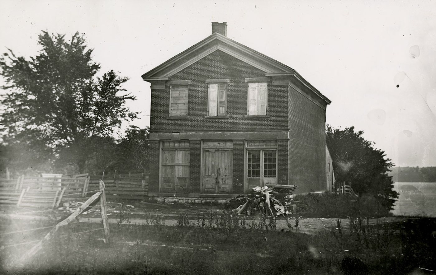 Joseph Smith's red brick store in Nauvoo, photographed in 1885 after it had fallen into disrepair. The Relief Society was organized in its upper room.